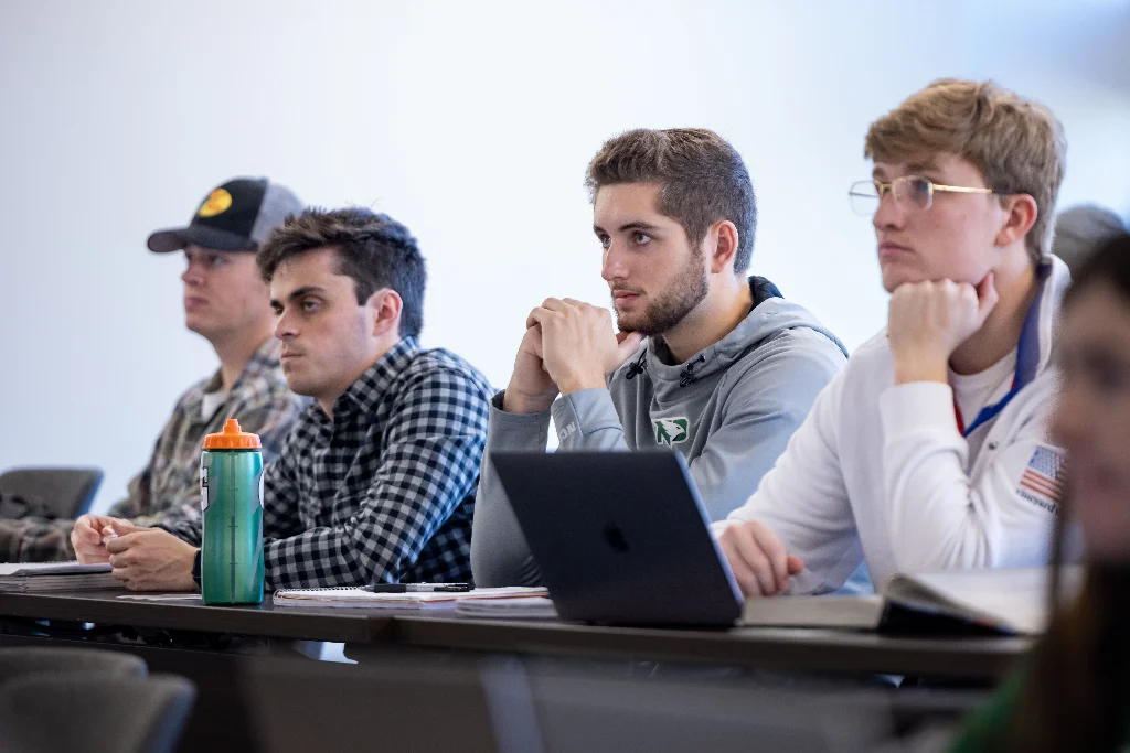 Business administration students listening to their professor in a lecture