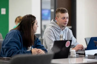 Group of political science students discussing a project together.