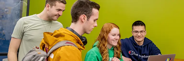 Group of engineering students at UND working together on a technical project in a campus study space.