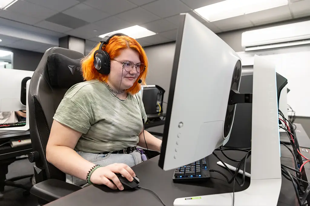 A UND esports student engaged in playing a game