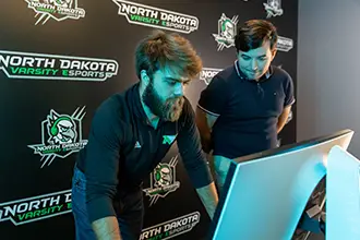 Two esports students focused on their gaming session.