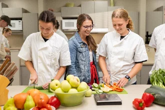 Nutrition students participate in a class, experimenting with fruits and vegetables to develop healthy recipes