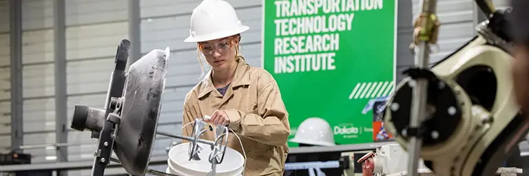 A student at the best engineering school in the Midwest preparing materials for a concrete or civil infrastructure project in the research lab.