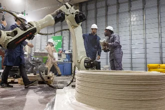 male students collaborating on a massive machine for a civil engineering project.