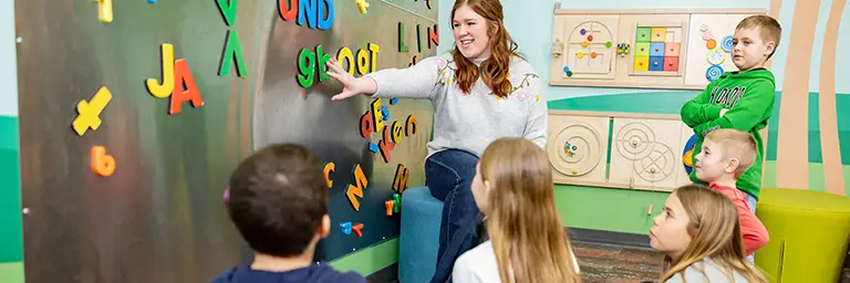 A UND early childhood education student teaching a young children's class