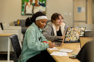 Two students collaborating on a revision session, discussing data science and AI concepts.