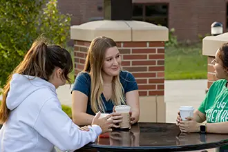 Students socializing and discussing ideas outside