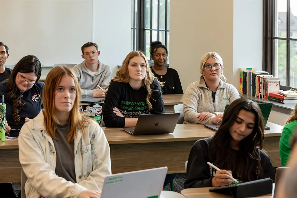 A classroom of MPA students attentively listening to the lecturer