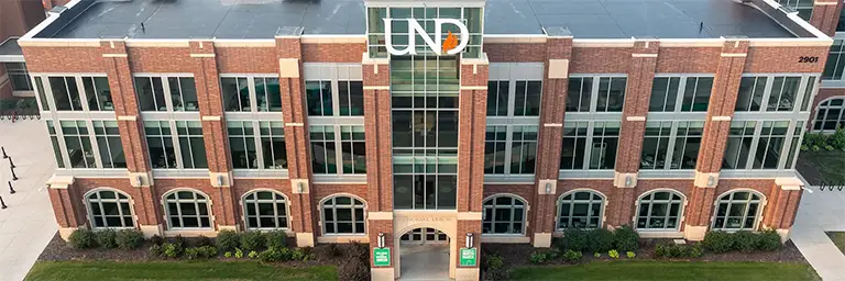 Aerial view of the University of North Dakota’s Memorial Union building with large glass windows and brick architecture, representing institutions offering ABET-accredited programs