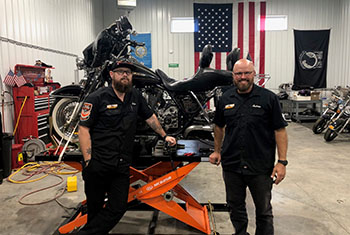 Owners of War-Torn Cycles pose in their repair shop