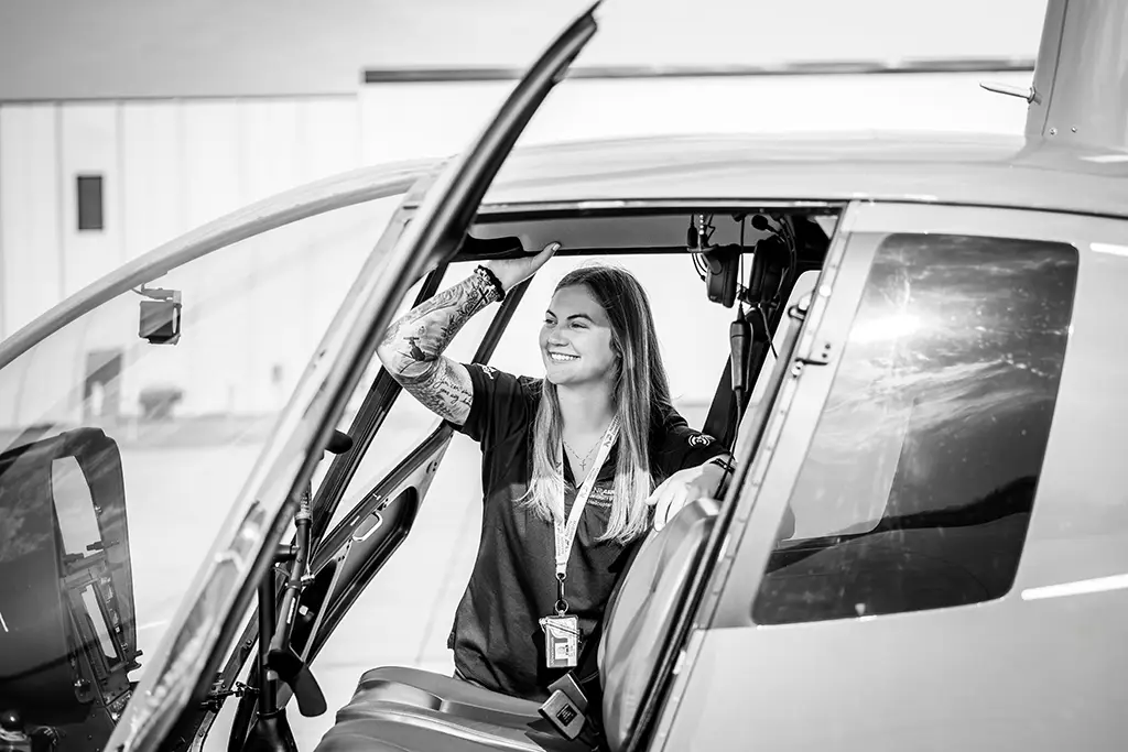 Ali sitting inside parked helicopter