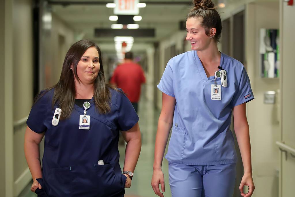 Amy Joshua walking with coworker