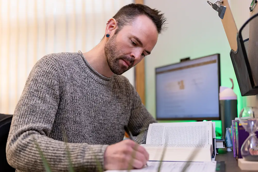 Austin taking notes in a meeting
