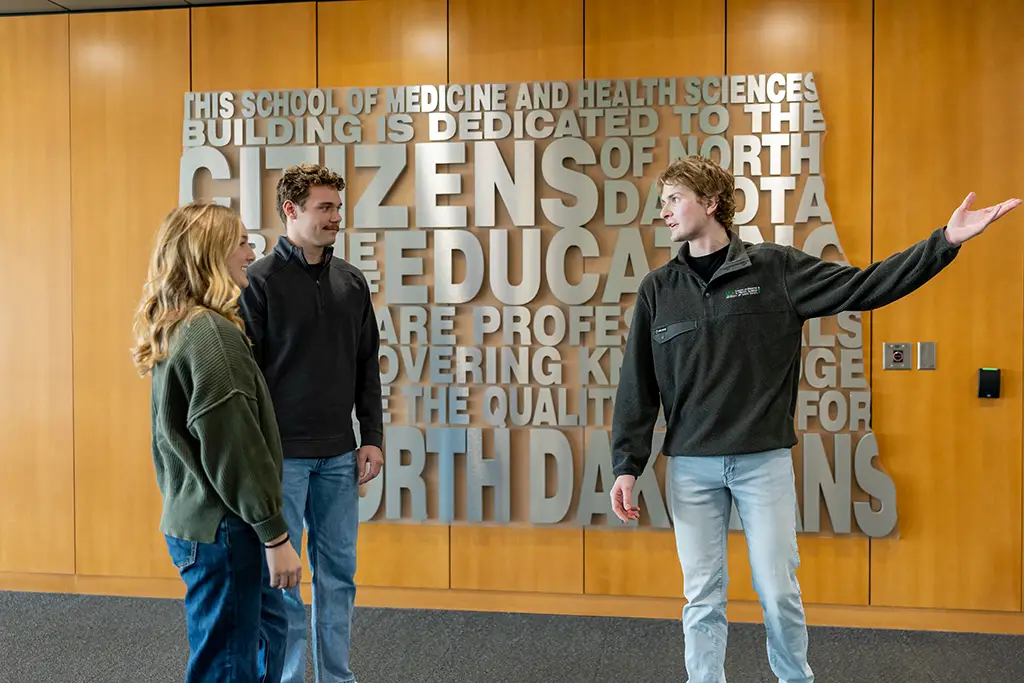 carson showing students around school of medicine & health sciences