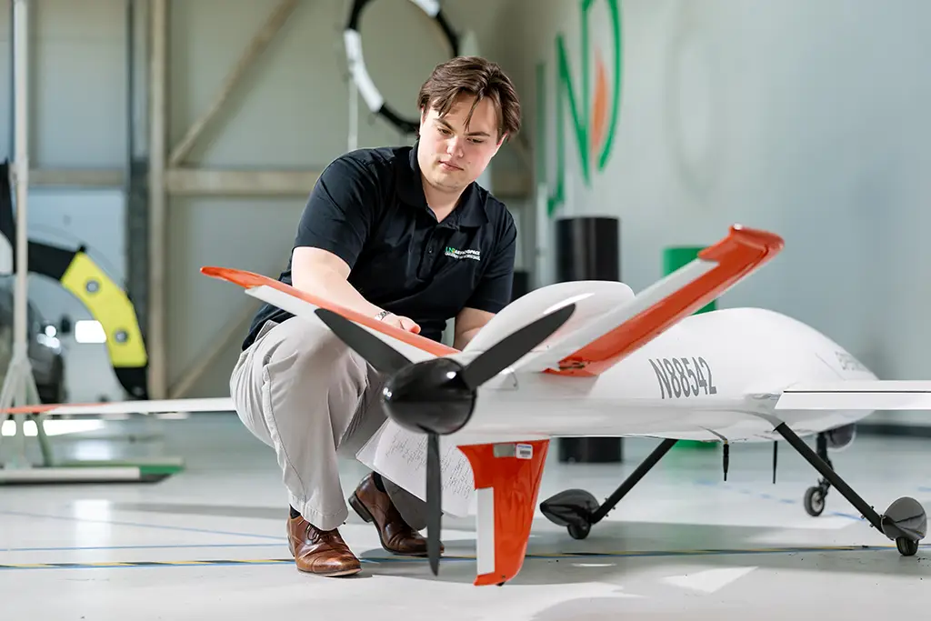 greyson working with unmanned aircraft system drone on und campus
