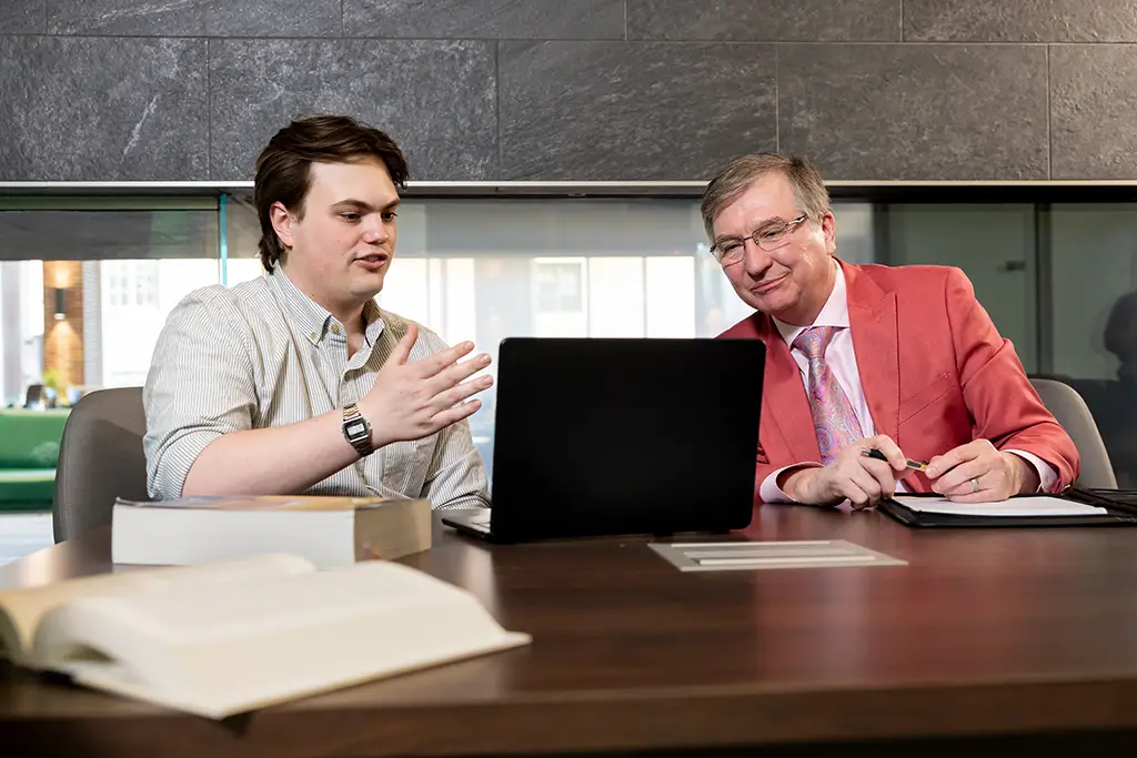 greyson working with UND faculty on a project