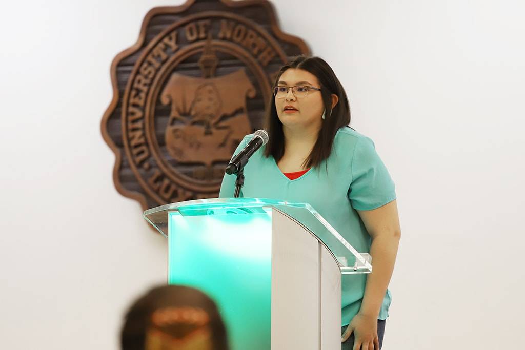 Speaking at a podium