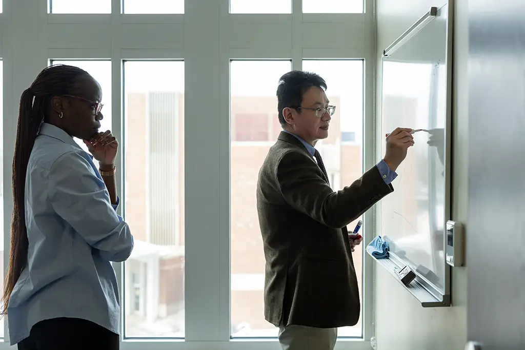 ismelda mashalia in classroom writing on white board