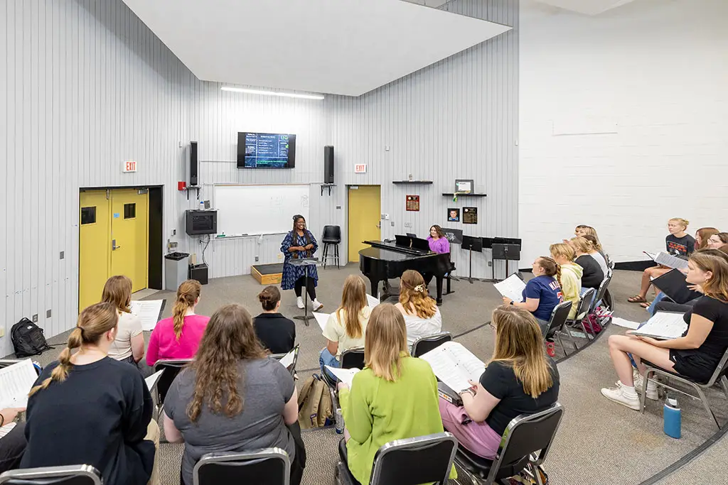 ketina conducting a group of music students