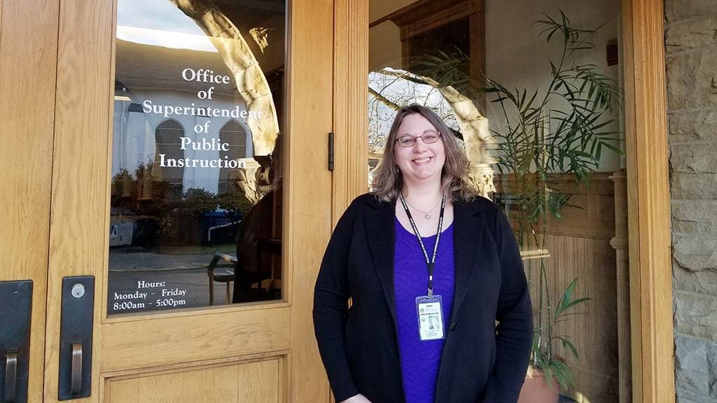 Laura in front of her office