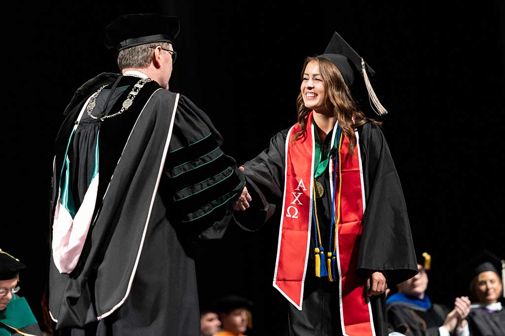 Lauren Cain accepts degree at Commencement