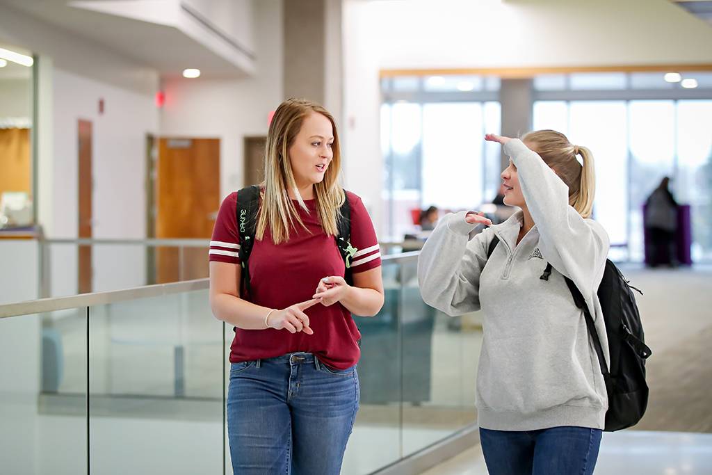 Madison Wahlen talking to another student