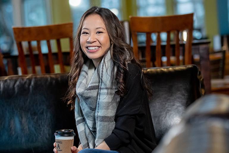 Michelle Nguyen smiling on couch