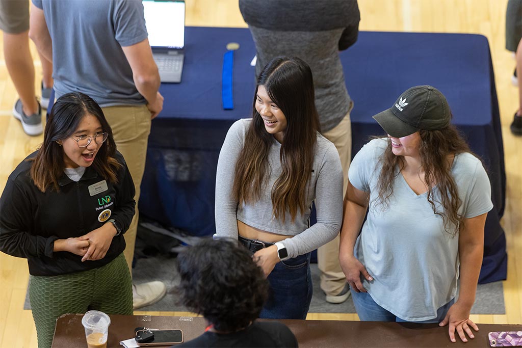 Nichole Dumlao and two women talking at table