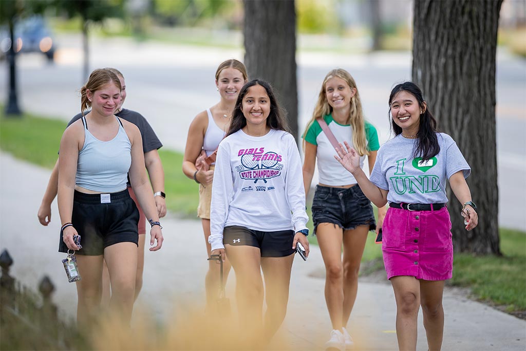 Nichole Dumlao showing 5 students campus on University Avenue.