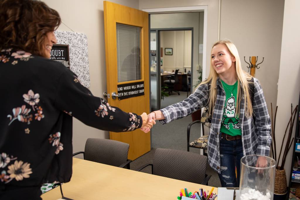 Olivia shaking hands with advisor