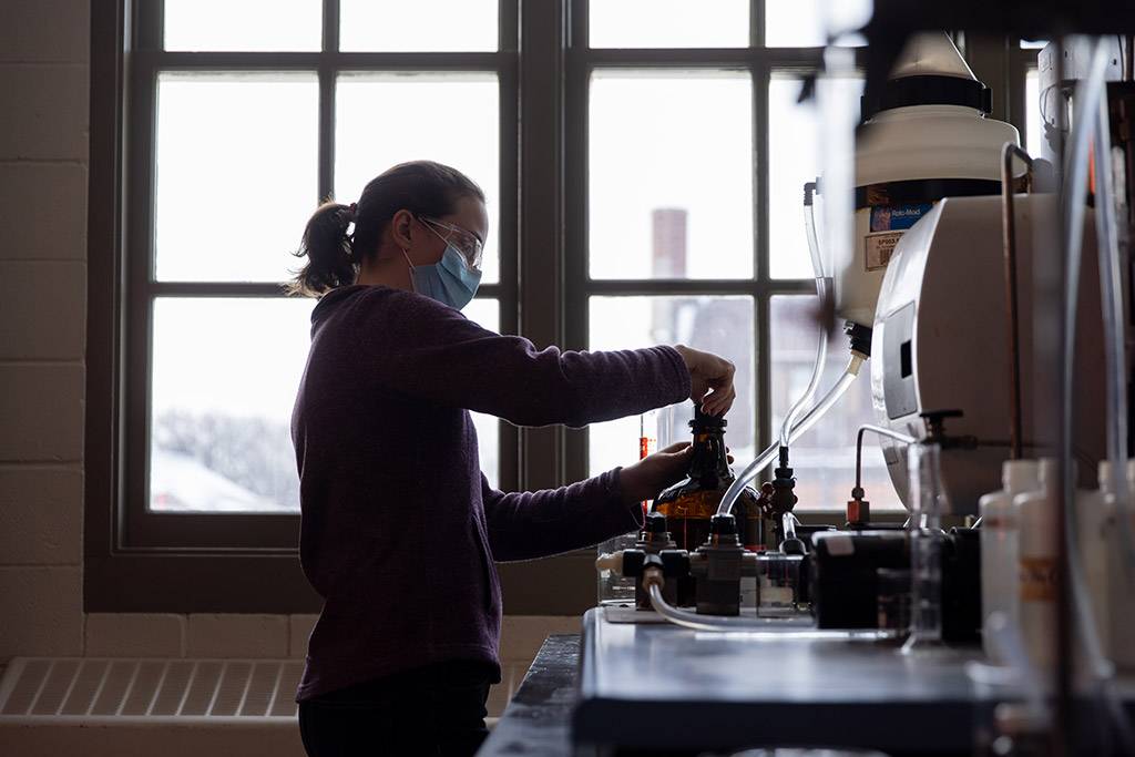 Rebecca pouring liquid into test tube