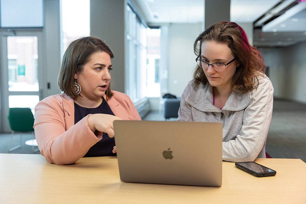 Professor and student on laptop