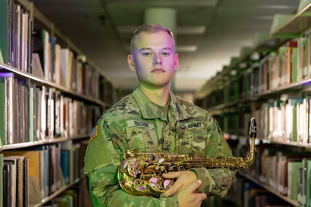 Zach Fischer holding a saxophone