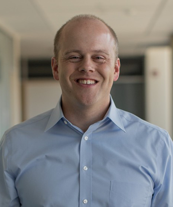 Headshot of Darin smiling with a blue shirt