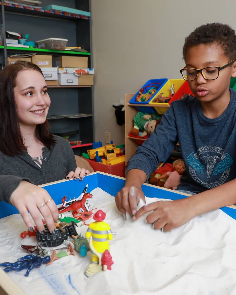 student helping child