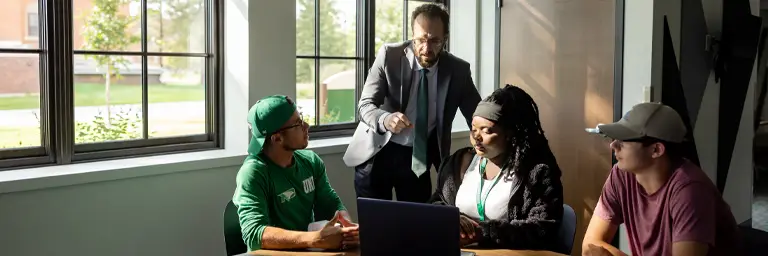 UND Professor and Students Working with Technology