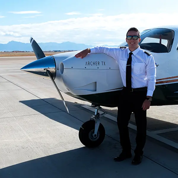 Cade Bice standing by plane