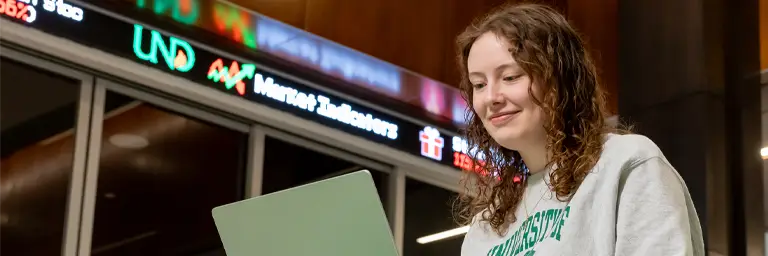 UND Business Student with Laptop in Nistler CoBPA by Ticker