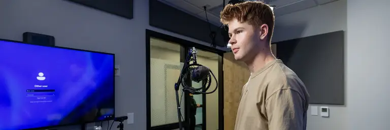 UND Communication Student by Microphone