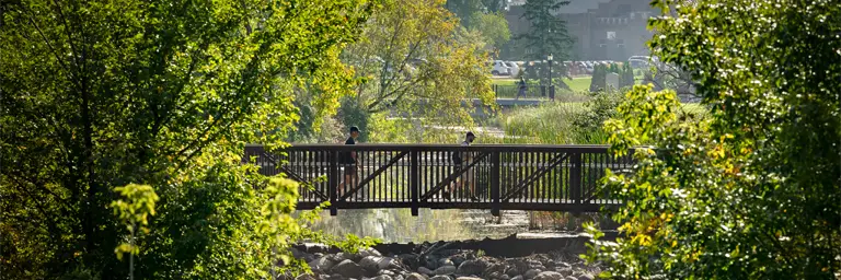UND Students Walking Across Bridge Above English Coulee