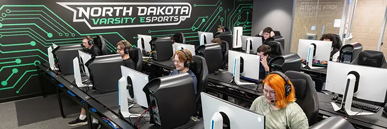 UND Student on a computer with headset