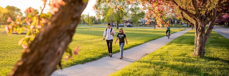 health studies students walking on campus