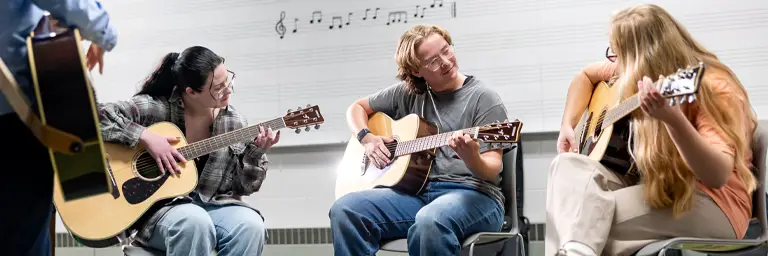 UND Music Therapy Students Playing the Guitar in Classroom