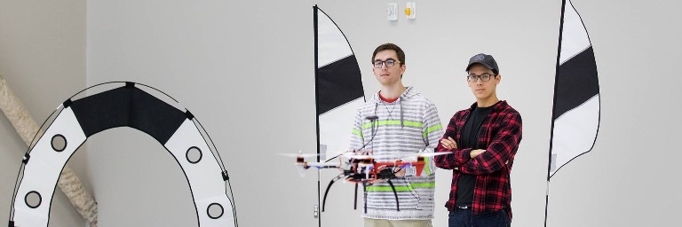 unmanned aircraft system operations students with drone in lab