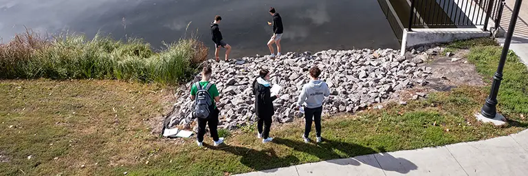 civil engineering students assessing body of water