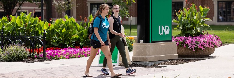 women walking on campus