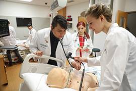 Native medical students working on simulator