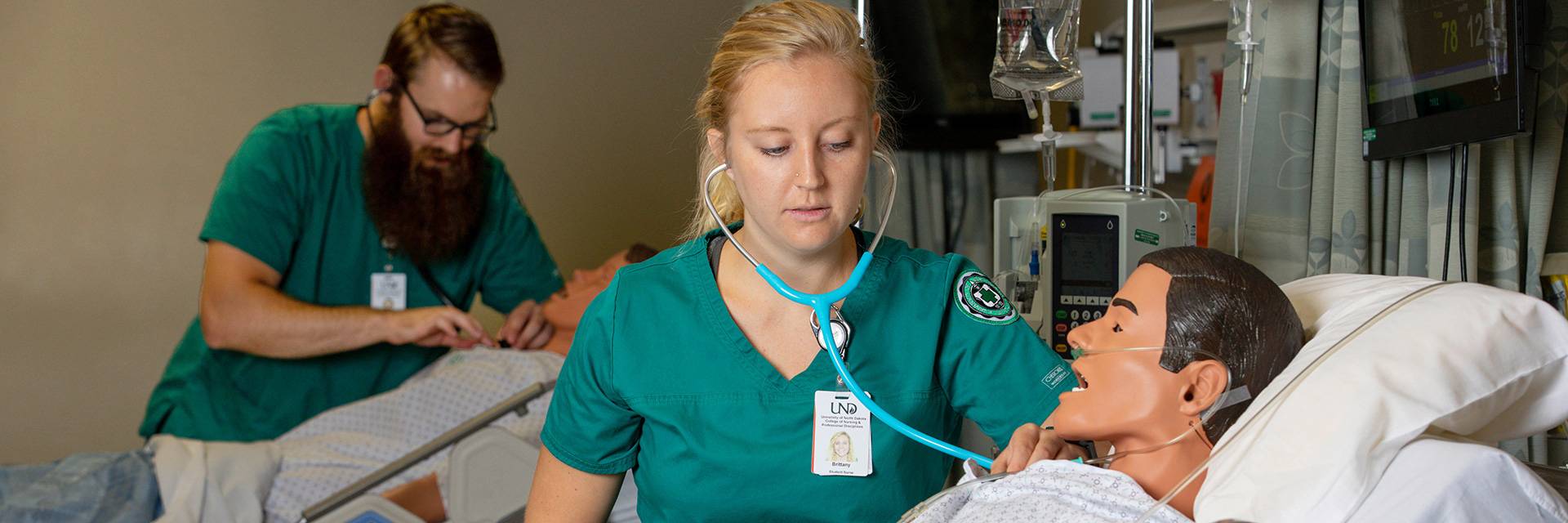 two nursing students with simulators