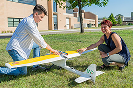 student and professor with plane