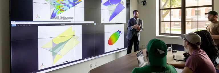 Dean Ryan Adams presenting cutting-edge engineering research visualizations to students